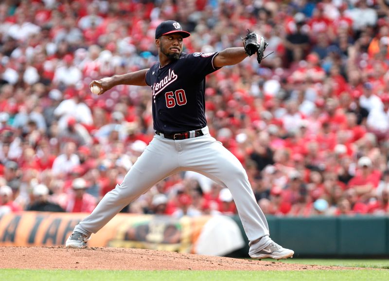 Aug 5, 2023; Cincinnati, Ohio, USA; Washington Nationals Joan Adon (60) throws against the Cincinnati Reds during the second inning at Great American Ball Park. Mandatory Credit: David Kohl-USA TODAY Sports