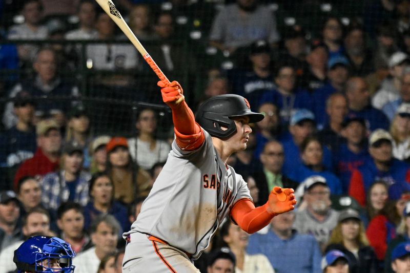 May 6, 2025; Chicago, Illinois, USA;  San Francisco Giants catcher Patrick Bailey (14) hits an RBI single against the Chicago Cubs during the eleventh inning at Wrigley Field. Mandatory Credit: Matt Marton-Imagn Images