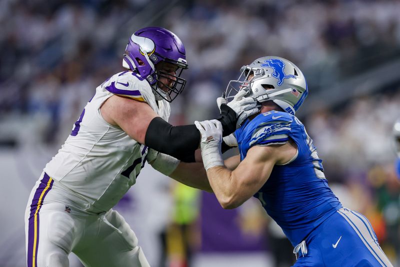 Minnesota Vikings offensive tackle David Quessenberry (76) moves against Detroit Lions defensive end Aidan Hutchinson (97) during the second half of an NFL football game Sunday, Dec. 24, 2023 in Minneapolis. (AP Photo/Stacy Bengs)