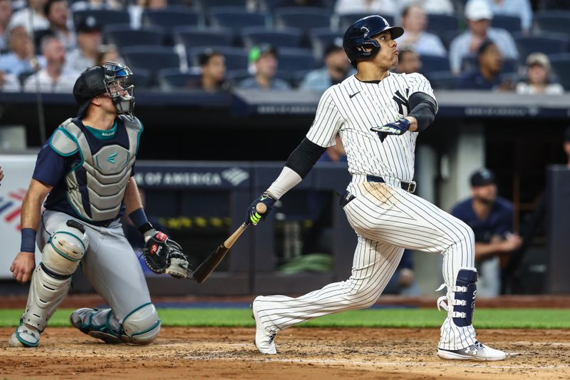 May 22, 2024; Bronx, New York, USA;  New York Yankees right fielder Juan Soto (22) hits a two-run home run in the third inning against the Seattle Mariners at Yankee Stadium. Mandatory Credit: Wendell Cruz-USA TODAY Sports