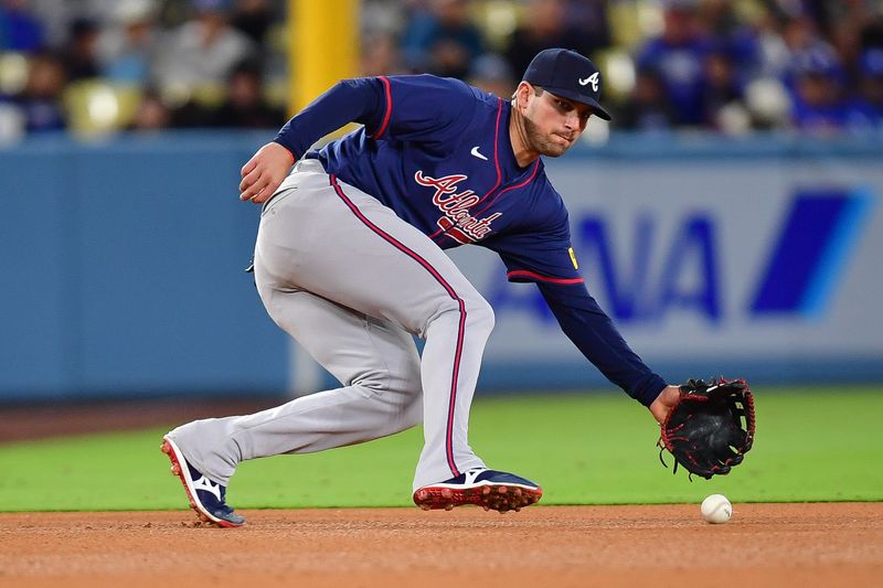 May 4, 2024; Los Angeles, California, USA; Atlanta Braves third baseman Austin Riley (27) fields the ground ball of Los Angeles Dodgers catcher Will Smith (16) during the eighth inning at Dodger Stadium. Mandatory Credit: Gary A. Vasquez-USA TODAY Sports