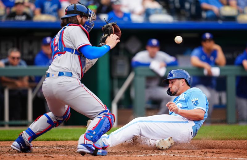 Apr 19, 2023; Kansas City, Missouri, USA; Kansas City Royals first baseman Vinnie Pasquantino (9) slides into home plate past Texas Rangers catcher Jonah Heim (28) during the sixth inning at Kauffman Stadium. Mandatory Credit: Jay Biggerstaff-USA TODAY Sports