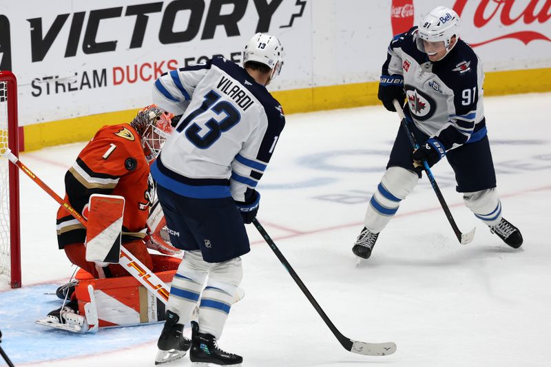 Nov 9, 2025; Anaheim, California, USA;  Anaheim Ducks goaltender Lukas Dostal (1) blocks the shot during the third period against the Winnipeg Jets at Honda Center. Mandatory Credit: Kiyoshi Mio-Imagn Images