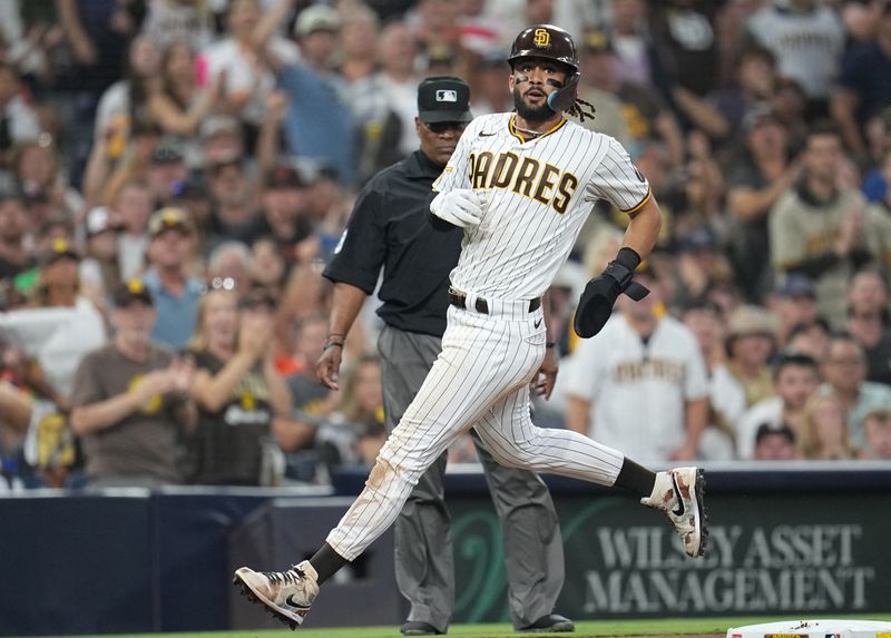 Aug 16, 2023; San Diego, California, USA;  San Diego Padres right fielder Fernando Tatis Jr. (23) advances to third base on a throwing error by Baltimore Orioles relief pitcher Cionel Perez (not pictured) during the seventh inning at Petco Park. Mandatory Credit: Ray Acevedo-USA TODAY Sports