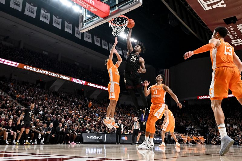 Feb 21, 2023; College Station, Texas, USA;  Texas A&M Aggies forward Julius Marble (34) drives to the basket against Tennessee Volunteers guard Santiago Vescovi (25) during the second half at Reed Arena. Mandatory Credit: Maria Lysaker-USA TODAY Sports