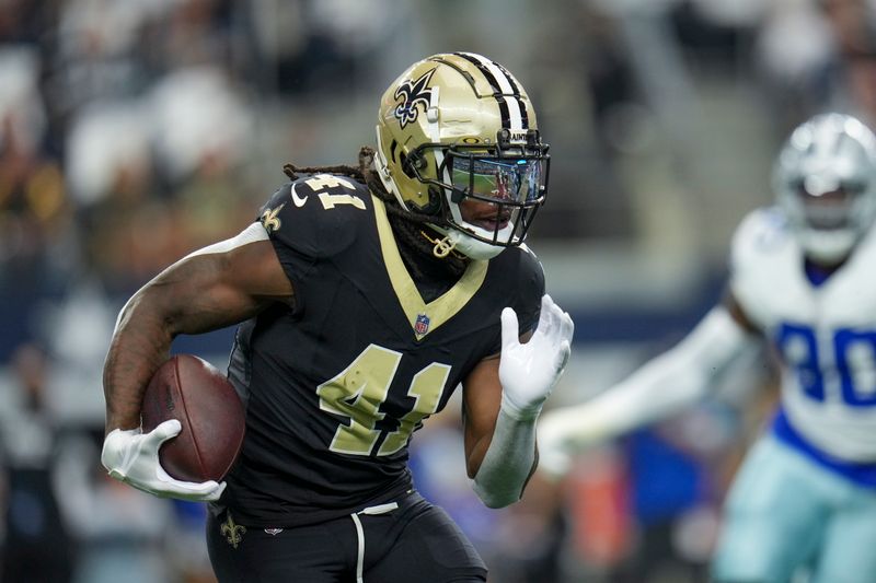 New Orleans Saints running back Alvin Kamara runs with the ball against the Dallas Cowboys during the first half of an NFL football game, Sunday, Sept. 15, 2024, in Arlington, Texas. (AP Photo/Jeffrey McWhorter)