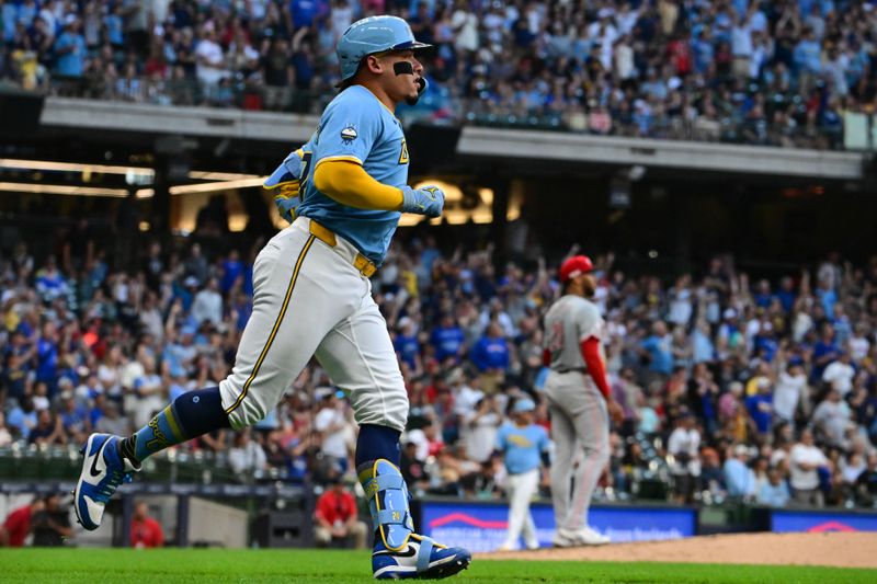 Jun 14, 2024; Milwaukee, Wisconsin, USA; Milwaukee Brewers  catcher William Contreras (24) hits a solo home run against Cincinnati Reds starting pitcher Hunter Greene (21) in the third inning at American Family Field. Mandatory Credit: Benny Sieu-USA TODAY Sports