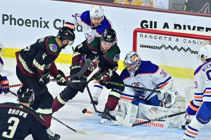 Mar 27, 2023; Tempe, Arizona, USA;  Edmonton Oilers goaltender Jack Campbell (36) makes a save as Arizona Coyotes defenseman Josh Brown (3), defenseman Juuso Valimaki (4) and center Barrett Hayton (29) attack in the first period at Mullett Arena. Mandatory Credit: Matt Kartozian-USA TODAY Sports