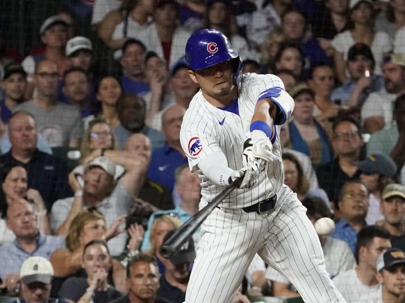 Jun 18, 2024; Chicago, Illinois, USA; Chicago Cubs outfielder Seiya Suzuki (27) hits a single against the San Francisco Giants during the eighth inning at Wrigley Field. Mandatory Credit: David Banks-USA TODAY Sports