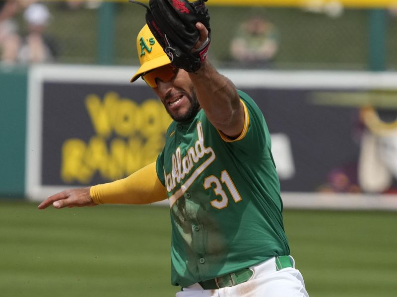 Mar 23, 2024; Mesa, Arizona, USA; Oakland Athletics third baseman Abraham Toro (31) makes the play for an out against the Los Angeles Angels in the third inning at Hohokam Stadium. Mandatory Credit: Rick Scuteri-USA TODAY Sports