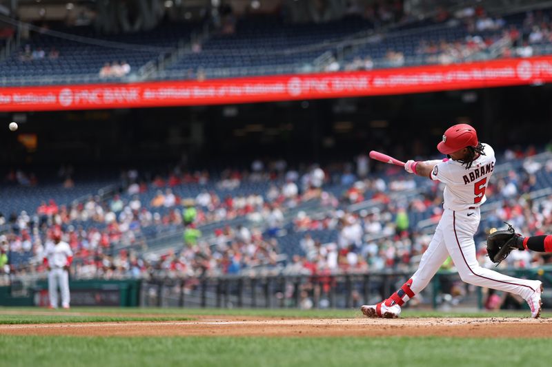 May 11, 2025; Washington, District of Columbia, USA; Washington Nationals shortstop CJ Abrams (5) singles against the St. Louis Cardinals during the first inning at Nationals Park. Mandatory Credit: Geoff Burke-Imagn Images