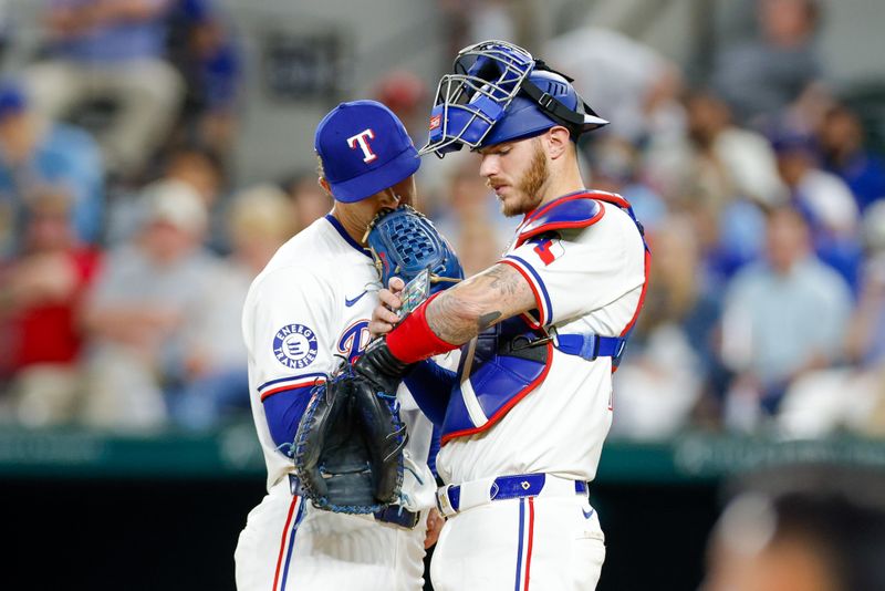 May 13, 2024; Arlington, Texas, USA; Texas Rangers catcher Jonah Heim (28) talks with pitcher Jacob Latz (67) during the eighth inning against the Cleveland Guardians at Globe Life Field. Mandatory Credit: Andrew Dieb-USA TODAY Sports