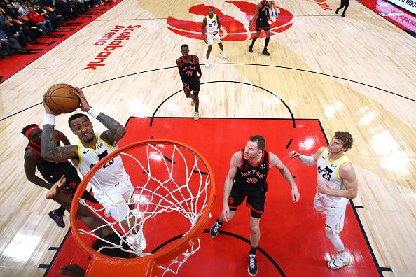 TORONTO, CANADA - DECEMBER 23:  John Collins #20 of the Utah Jazz drives to the basket during the game against the Toronto Raptors on December 23, 2023 at the Scotiabank Arena in Toronto, Ontario, Canada.  NOTE TO USER: User expressly acknowledges and agrees that, by downloading and or using this Photograph, user is consenting to the terms and conditions of the Getty Images License Agreement.  Mandatory Copyright Notice: Copyright 2023 NBAE (Photo by Vaughn Ridley/NBAE via Getty Images)