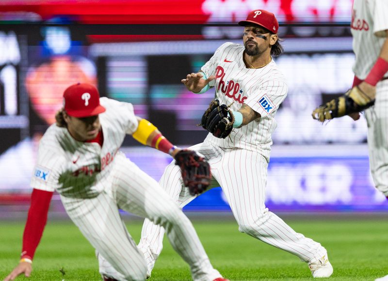 Sep 11, 2024; Philadelphia, Pennsylvania, USA; Philadelphia Phillies outfielder Nick Castellanos (8) makes a running catch behind second base Bryson Stott (5) on the pop up of Tampa Bay Rays shortstop Junior Caminero (13) during the eighth inning at Citizens Bank Park. Mandatory Credit: Bill Streicher-Imagn Images