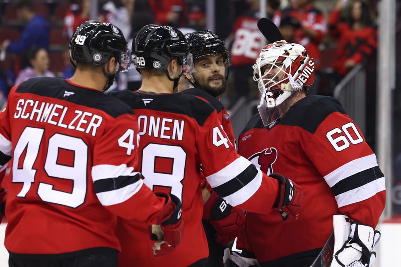 Sep 30, 2024; Newark, New Jersey, USA; The New Jersey Devils celebrate their win over the New York Rangers at Prudential Center. Mandatory Credit: Ed Mulholland-Imagn Images