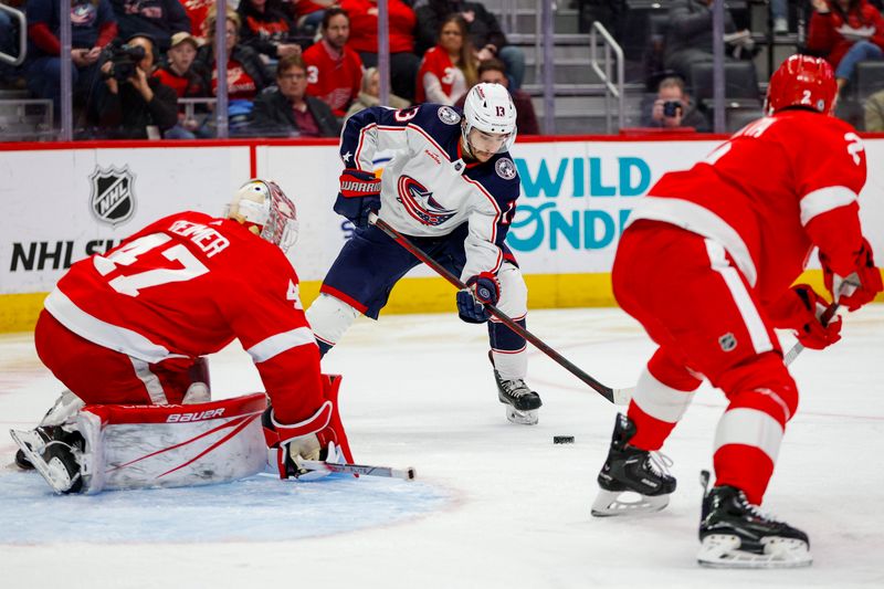 Mar 19, 2024; Detroit, Michigan, USA; Columbus Blue Jackets left wing Johnny Gaudreau (13) handles the puck in front of the net during the first period of the game against the Detroit Red Wings at Little Caesars Arena. Mandatory Credit: Brian Bradshaw Sevald-USA TODAY Sports