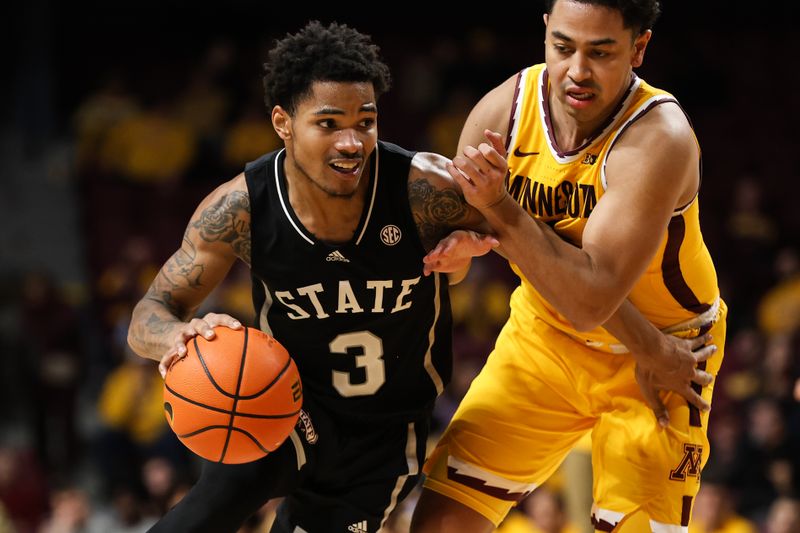 Dec 11, 2022; Minneapolis, Minnesota, USA; Mississippi State Bulldogs guard Shakeel Moore (3) dribbles while Minnesota Golden Gophers guard Taurus Samuels (0) defends during the second half at Williams Arena. Mandatory Credit: Matt Krohn-USA TODAY Sports