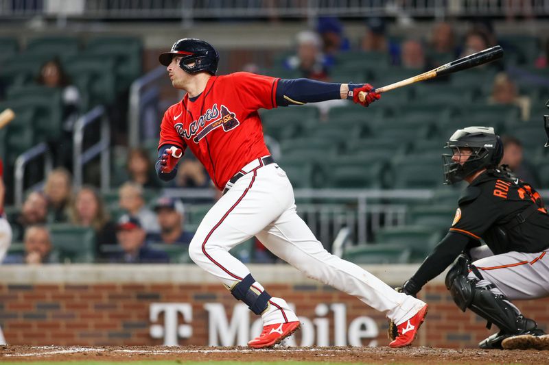 May 5, 2023; Atlanta, Georgia, USA; Atlanta Braves third baseman Austin Riley (27) hits a single against the Baltimore Orioles in the eighth inning at Truist Park. Mandatory Credit: Brett Davis-USA TODAY Sports