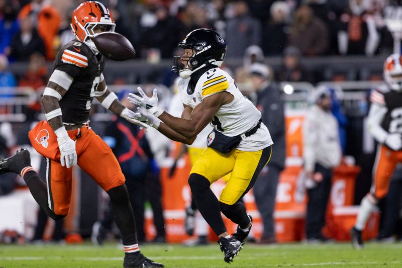 Pittsburgh Steelers wide receiver Calvin Austin III (19) catches a pass in front of Cleveland Browns safety Grant Delpit (9) during an NFL football game, Thursday, Nov. 21, 2024, in Cleveland. (AP Photo/Matt Durisko)