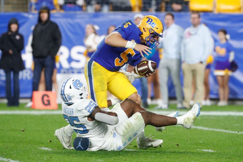 Sep 23, 2023; Pittsburgh, Pennsylvania, USA; North Carolina Tar Heels linebacker Kaimon Rucker (25) sacks Pittsburgh Panthers quarterback Phil Jurkovec (5) during the second quarter at Acrisure Stadium. Mandatory Credit: Charles LeClaire-USA TODAY Sports