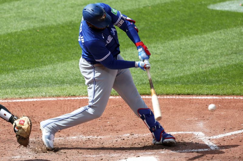 Apr 13, 2025; Baltimore, Maryland, USA; Toronto Blue Jays first baseman Vladimir Guerrero Jr. (27) hits a single during the fifth inning against the Baltimore Orioles at Oriole Park at Camden Yards. Mandatory Credit: Daniel Kucin Jr.-Imagn Images