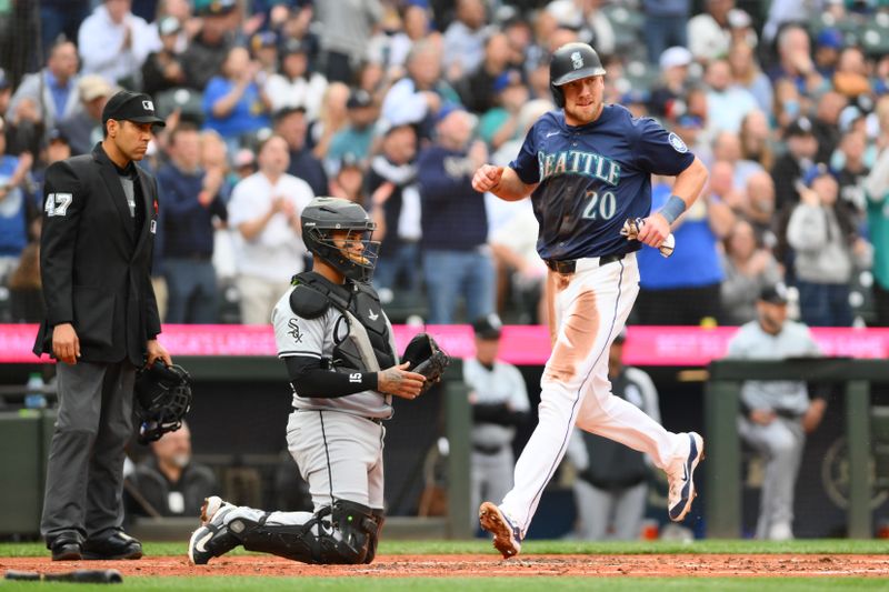 Jun 11, 2024; Seattle, Washington, USA; Seattle Mariners first baseman Luke Raley (20) scores a run against the Chicago White Sox during the second inning at T-Mobile Park. Mandatory Credit: Steven Bisig-USA TODAY Sports