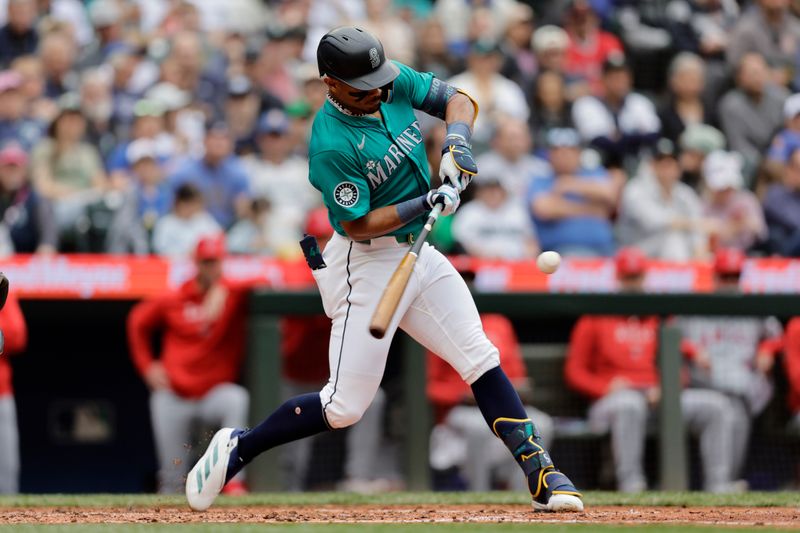 Jun 1, 2024; Seattle, Washington, USA;  Seattle Mariners center fielder Julio Rodríguez (44) hits an RBI single against the Los Angeles Angels during the third inning at T-Mobile Park. Mandatory Credit: John Froschauer-USA TODAY Sports