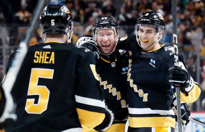 Apr 11, 2024; Pittsburgh, Pennsylvania, USA; Pittsburgh Penguins defenseman Ryan Shea (5) and defenseman Jack St. Ivany (3) congratulate center Jeff Carter (77) on his short-handed goal against the Detroit Red Wings during the third period at PPG Paints Arena. Pittsburgh won 6-5 in overtime. Mandatory Credit: Charles LeClaire-USA TODAY Sports