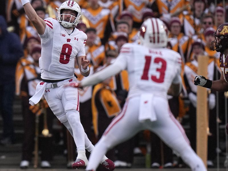 Nov 25, 2023; Minneapolis, Minnesota, USA; Wisconsin Badgers quarterback Tanner Mordecai (8) completes a 35-yard reception to wide receiver Chimere Dike (13) against the Minnesota Golden Gophers during the second quarter at Huntington Bank Stadium. Mandatory Credit: Mark Hoffman/Milwaukee Journal Sentinel via USA TODAY NETWORK