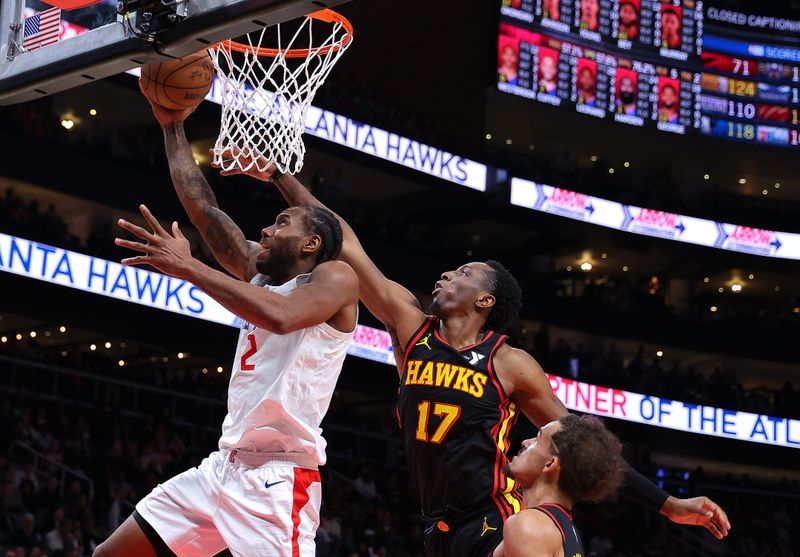 ATLANTA, GEORGIA - FEBRUARY 05:  Kawhi Leonard #2 of the LA Clippers attacks the basket against Onyeka Okongwu #17 and Trae Young #11 of the Atlanta Hawks during the fourth quarter at State Farm Arena on February 05, 2024 in Atlanta, Georgia.  NOTE TO USER: User expressly acknowledges and agrees that, by downloading and/or using this photograph, user is consenting to the terms and conditions of the Getty Images License Agreement.  (Photo by Kevin C. Cox/Getty Images)