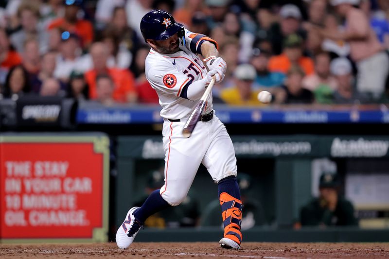 May 14, 2024; Houston, Texas, USA; Houston Astros second baseman Jose Altuve (27) hits a double to left field against the Oakland Athletics during the fifth inning at Minute Maid Park. Mandatory Credit: Erik Williams-USA TODAY Sports