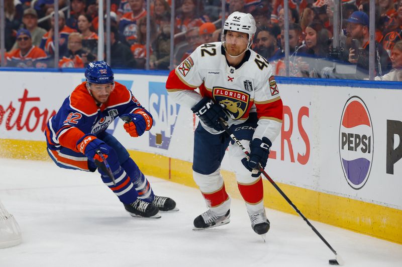 Jun 4, 2025; Edmonton, Alberta, CAN; Florida Panthers defenseman Gustav Forsling (42) skates with the puck past Edmonton Oilers right wing Vasily Podkolzin (92) during the first period in game one of the 2025 Stanley Cup Final at Rogers Place. Mandatory Credit: Perry Nelson-Imagn Images