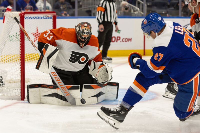 Nov 25, 2023; Elmont, New York, USA; Philadelphia Flyers goaltender Samuel Ersson (33) makes a save against the New York Islanders during the second period at UBS Arena. Mandatory Credit: Thomas Salus-USA TODAY Sports