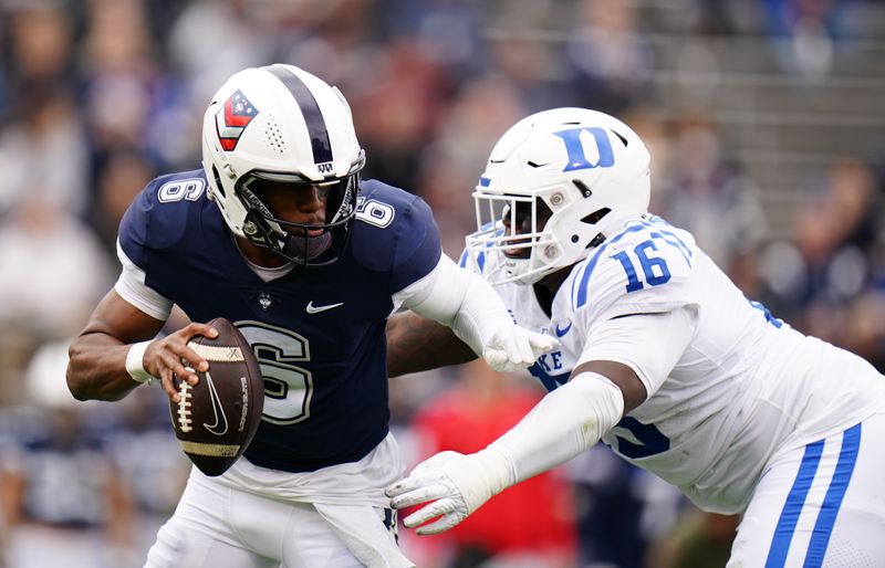 Sep 23, 2023; East Hartford, Connecticut, USA; UConn Huskies quarterback Ta'Quan Roberson (6) is sacked by Duke Blue Devils defensive tackle Aeneas Peebles (16) in the second quarter at Rentschler Field at Pratt & Whitney Stadium. Mandatory Credit: David Butler II-USA TODAY Sports