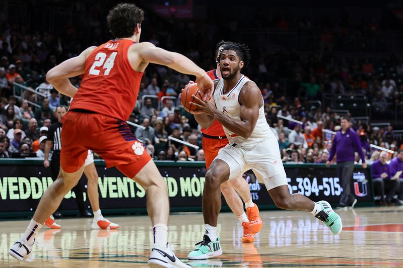 Jan 3, 2024; Coral Gables, Florida, USA; Miami Hurricanes forward Norchad Omier (15) drives to the basket against Clemson Tigers center PJ Hall (24) during the second half at Watsco Center. Mandatory Credit: Sam Navarro-USA TODAY Sports