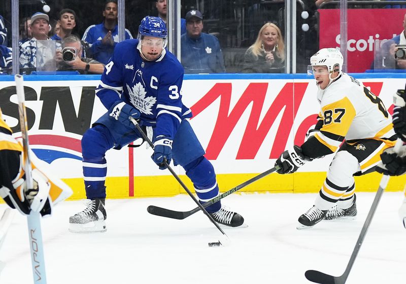 Oct 12, 2024; Toronto, Ontario, CAN; Toronto Maple Leafs center Auston Matthews (34) battles for the puck with Pittsburgh Penguins center Sidney Crosby (87) during the third period at Scotiabank Arena. Mandatory Credit: Nick Turchiaro-Imagn Images