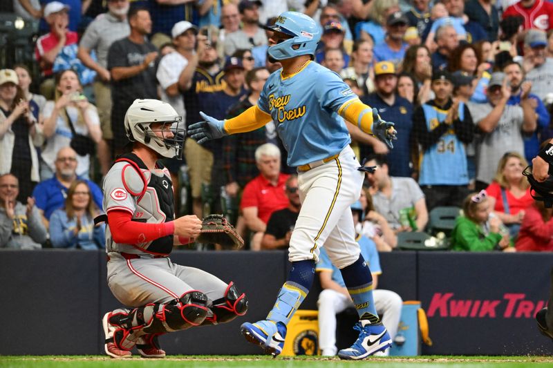 Jun 14, 2024; Milwaukee, Wisconsin, USA;  Milwaukee Brewers  catcher William Contreras (24) reacts after hitting a solo home run as Cincinnati Reds catcher Tyler Stephenson (37) looks on in the third inning at American Family Field. Mandatory Credit: Benny Sieu-USA TODAY Sports