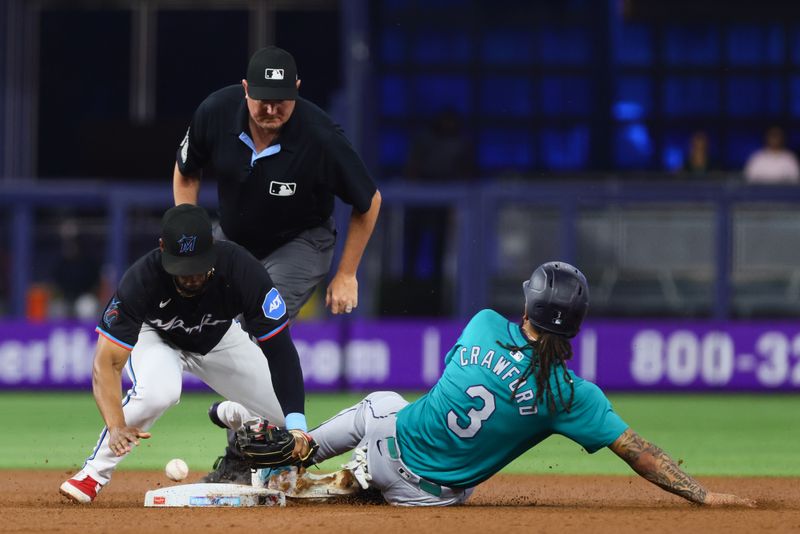 Jun 21, 2024; Miami, Florida, USA; Seattle Mariners shortstop J.P. Crawford (3) steals second base against Miami Marlins second baseman Otto Lopez (61) during the first inning at loanDepot Park. Mandatory Credit: Sam Navarro-USA TODAY Sports