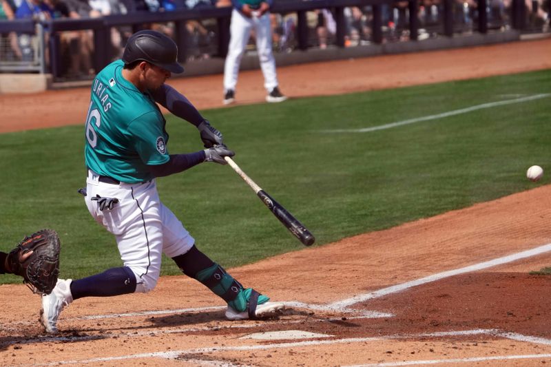 Mar 14, 2024; Peoria, Arizona, USA; Seattle Mariners third baseman Luis Urias (16) bats against the Milwaukee Brewers during the second inning at Peoria Sports Complex. Mandatory Credit: Joe Camporeale-USA TODAY Sports