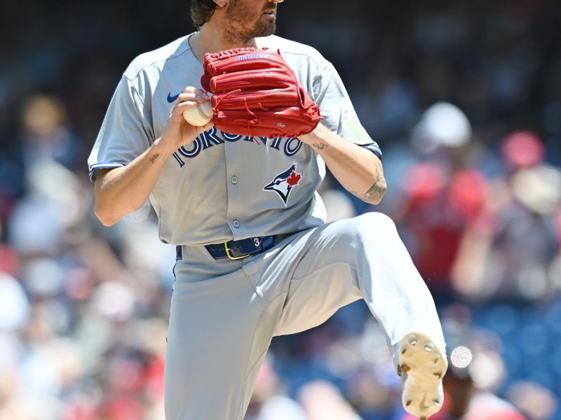 Jun 26, 2025; Cleveland, Ohio, USA; Toronto Blue Jays starting pitcher Kevin Gausman (34) throws a pitch during the first inning against the Cleveland Guardians at Progressive Field. Mandatory Credit: Ken Blaze-Imagn Images