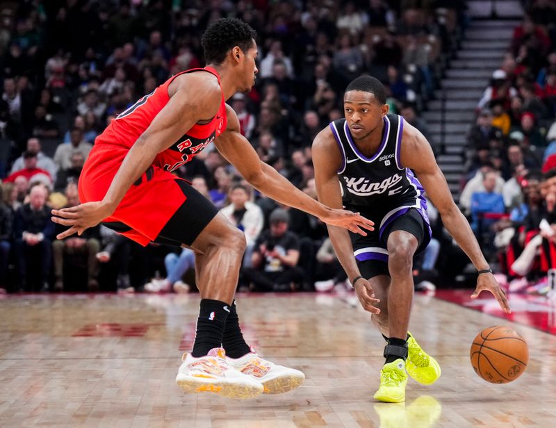 TORONTO, ON - MARCH 20: De'Aaron Fox #5 of the Sacramento Kings drives against Ochai Agbaji #30 of the Toronto Raptors during the first half at the Scotiabank Arena on March 20, 2024 in Toronto, Ontario, Canada. NOTE TO USER: User expressly acknowledges and agrees that, by downloading and/or using this Photograph, user is consenting to the terms and conditions of the Getty Images License Agreement. (Photo by Mark Blinch/Getty Images)