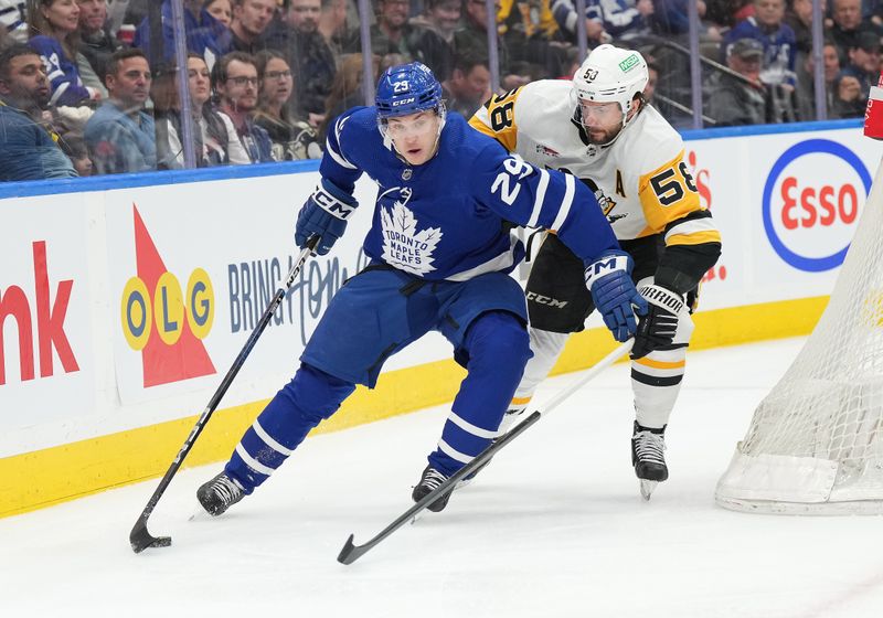 Apr 8, 2024; Toronto, Ontario, CAN; Toronto Maple Leafs right wing Pontus Holmberg (29) battles for the puck with Pittsburgh Penguins defenseman Kris Letang (58) during the first period at Scotiabank Arena. Mandatory Credit: Nick Turchiaro-USA TODAY Sports