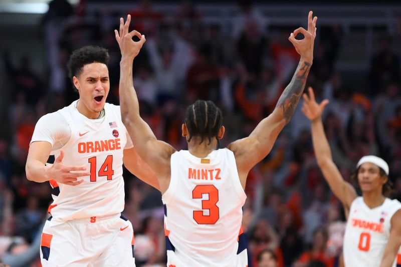 Feb 14, 2023; Syracuse, New York, USA; Syracuse Orange center Jesse Edwards (14) celebrates a made three-point basket with teammate guard Judah Mintz (3) against the North Carolina State Wolfpack during the second half at the JMA Wireless Dome. Mandatory Credit: Rich Barnes-USA TODAY Sports