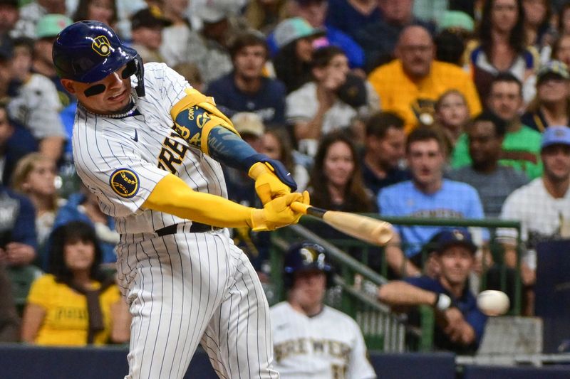 Aug 26, 2023; Milwaukee, Wisconsin, USA; Milwaukee Brewers catcher William Contreras (24) hits a triple to drive in two runs against the San Diego Padres in the fifth inning at American Family Field. Mandatory Credit: Benny Sieu-USA TODAY Sports