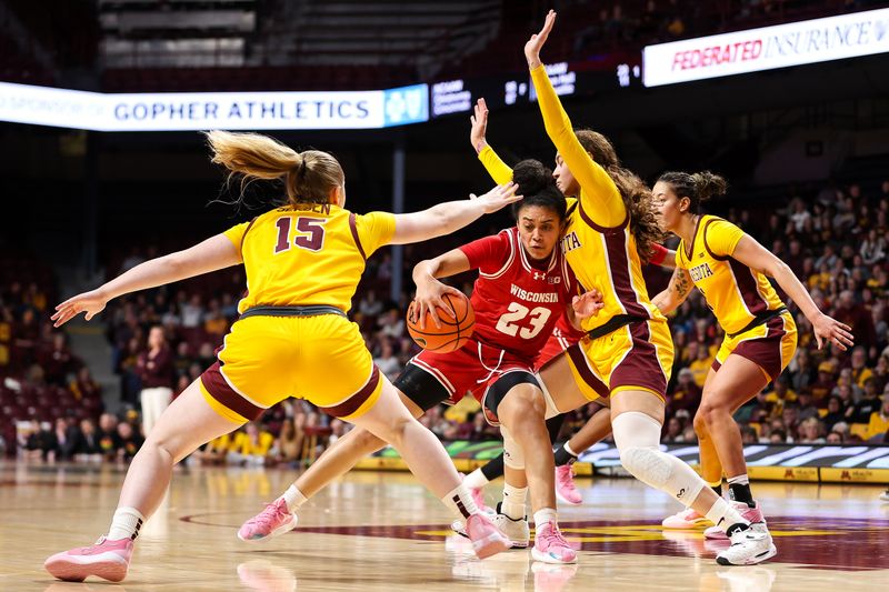 Feb 20, 2024; Minneapolis, Minnesota, USA; Wisconsin Badgers guard D'Yanis Jimenez (23) drives into Minnesota Golden Gophers guard Amaya Battle (3) during the second half at Williams Arena. Mandatory Credit: Matt Krohn-USA TODAY Sports