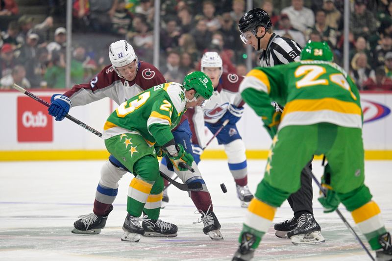 Nov 24, 2023; Saint Paul, Minnesota, USA; Minnesota Wild forward Marco Rossi (23) and Colorado Avalanche forward Frederik Olofsson (22) face-off during the first period at Xcel Energy Center. Mandatory Credit: Nick Wosika-USA TODAY Sports