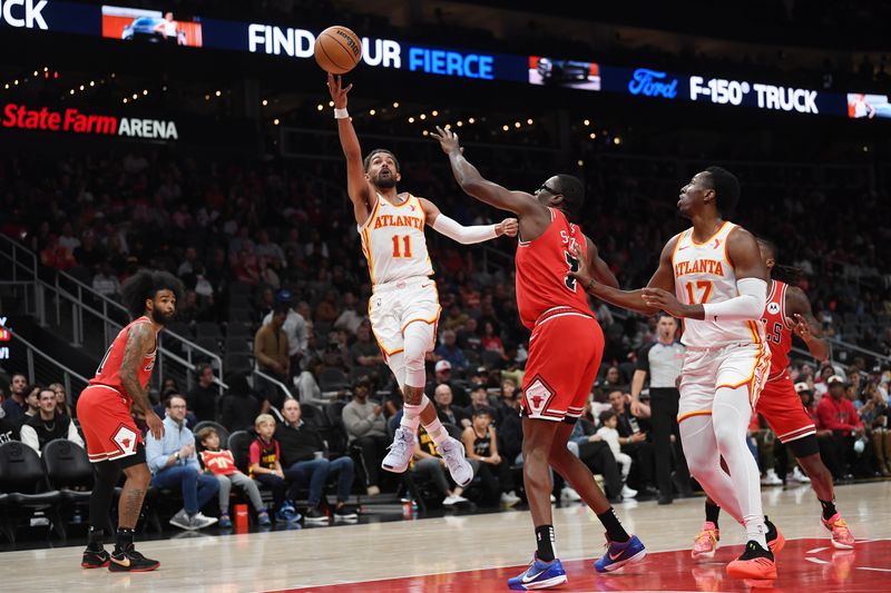 ATLANTA, GEORGIA - NOVEMBER 09:  Trae Young #11 of the Atlanta Hawks shoots the ball during the game against the Chicago Bulls on November 9, 2024 at State Farm Arena in Atlanta, Georgia.    NOTE TO USER: User expressly acknowledges and agrees that, by downloading and or using this photograph, User is consenting to the terms and conditions of the Getty Images License Agreement.  (Photo by Paras Griffin/Getty Images)