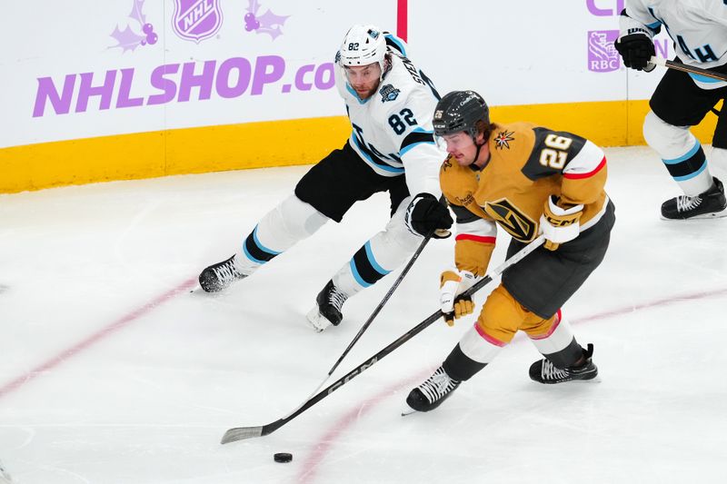 Nov 30, 2024; Las Vegas, Nevada, USA; Vegas Golden Knights right wing Alexander Holtz (26) skates against Utah Hockey Club center Kevin Stenlund (82) during the second period at T-Mobile Arena. Mandatory Credit: Stephen R. Sylvanie-Imagn Images