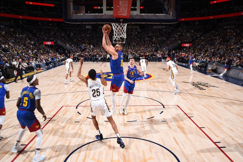 DENVER, CO - JANUARY 12: Nikola Jokic #15 of the Denver Nuggets grabs a rebound during the game against the New Orleans Pelicans on January 12, 2024 at the Ball Arena in Denver, Colorado. NOTE TO USER: User expressly acknowledges and agrees that, by downloading and/or using this Photograph, user is consenting to the terms and conditions of the Getty Images License Agreement. Mandatory Copyright Notice: Copyright 2024 NBAE (Photo by Garrett Ellwood/NBAE via Getty Images)