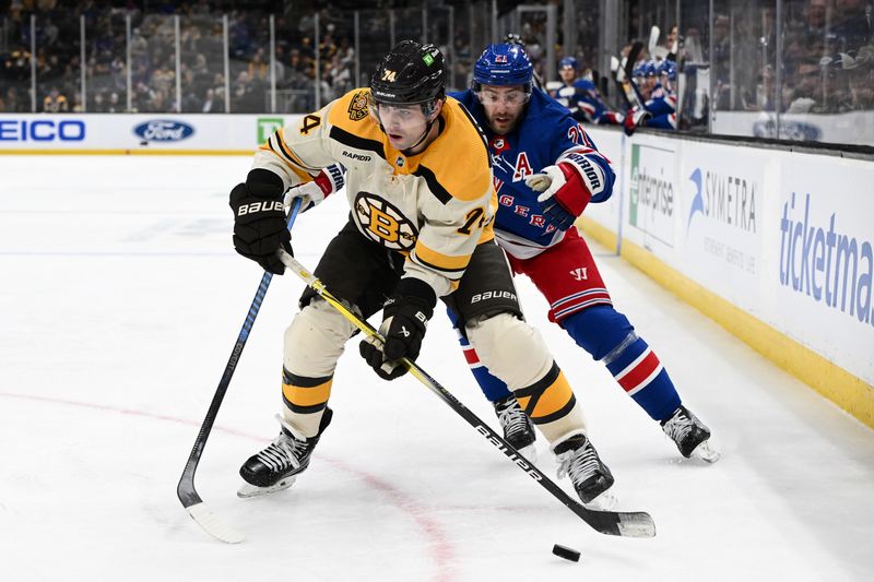 Mar 21, 2024; Boston, Massachusetts, USA; Boston Bruins left wing Jake DeBrusk (74) skates with the puck in front of New York Rangers center Barclay Goodrow (21) during the third period at the TD Garden. Mandatory Credit: Brian Fluharty-USA TODAY Sports